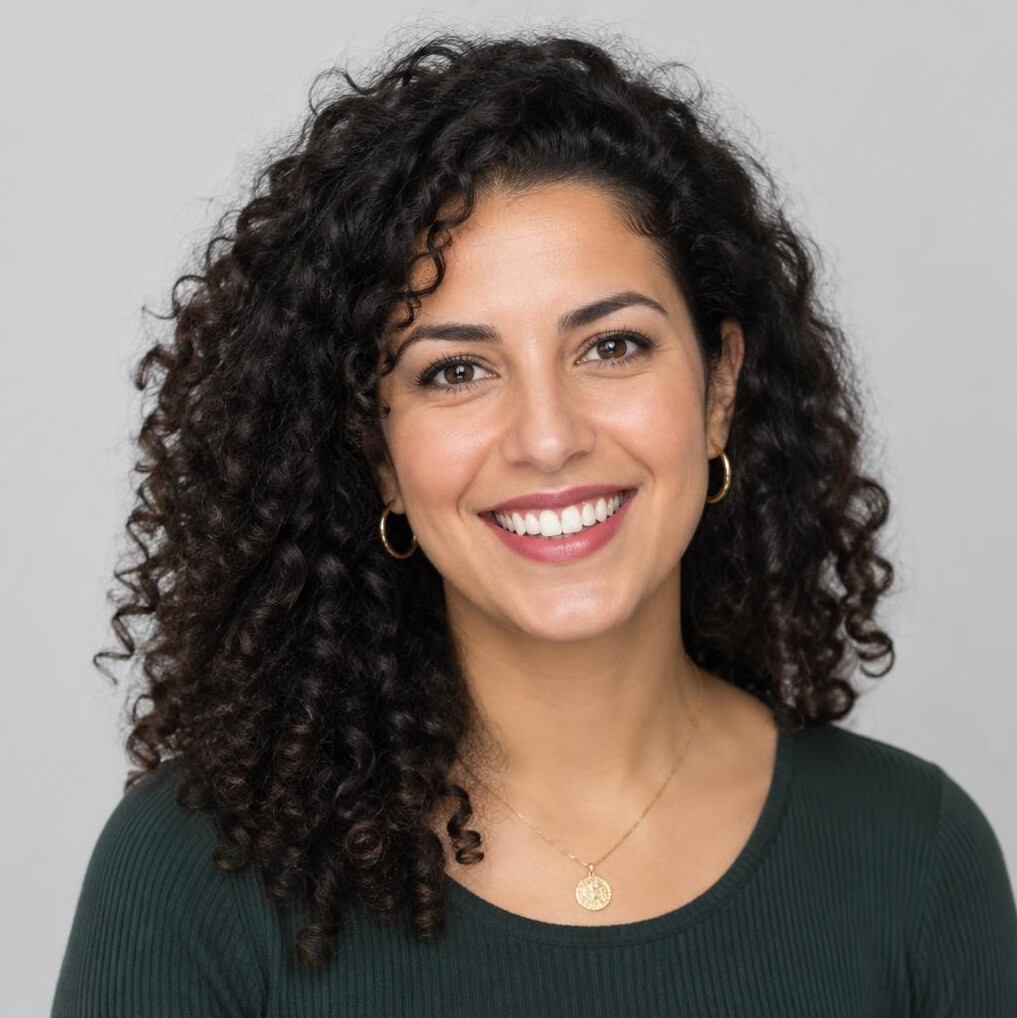 Studio portrait of a woman with curly hair smiling