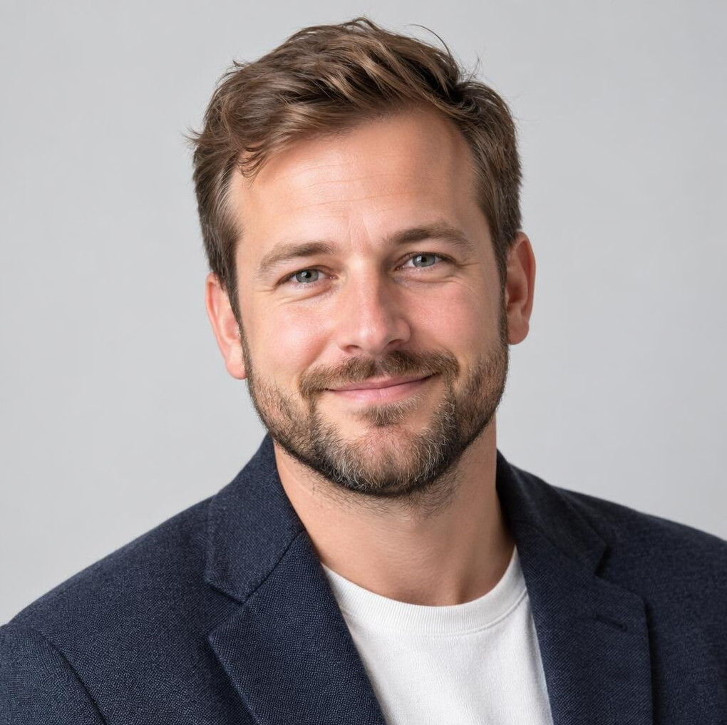 Studio portrait of a man with a beard smiling